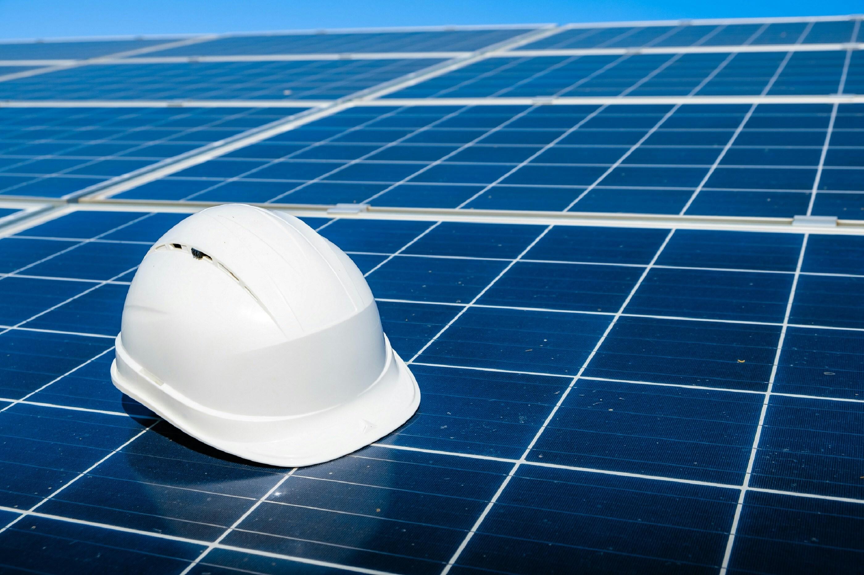 Hard hat resting on a solar module during construction