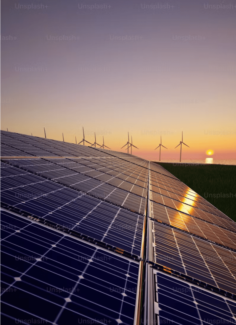 Solar array and wind turbines at dusk
